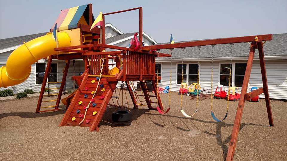A playset pressure washed and stained by one-80 Woodcare in Rochester MN